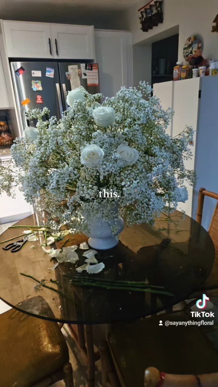 Cloud of baby’s breath in a pale blue pedestal urn